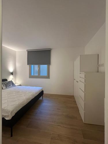 a bedroom with a bed and a dresser at Dimora Manganedda in Arzachena