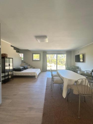 a room with a bed and a table and chairs at Dimora Manganedda in Arzachena