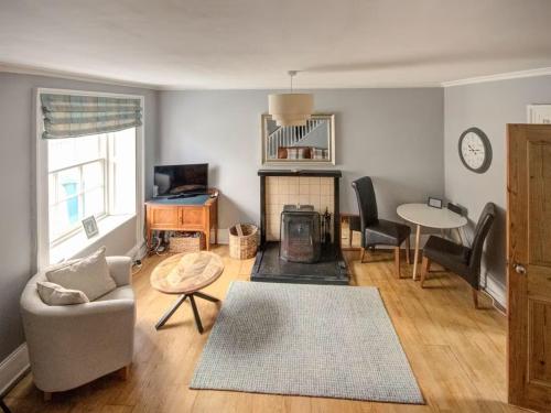 a living room with a couch and a table at Anvil House, Golspie in Golspie