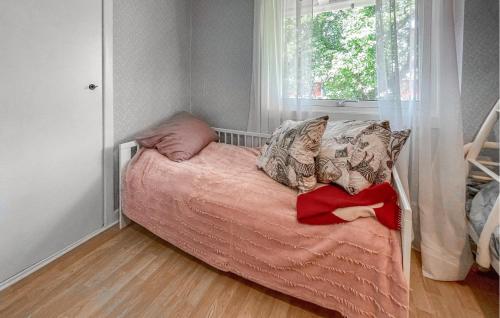 a small bed in a room with a window at Gorgeous Home In Östra Frölunda in Östra Frölunda