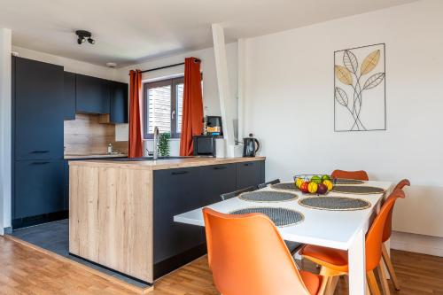 une cuisine et une salle à manger avec une table et des chaises dans l'établissement Le Saint-Jean - Hypercentre - Parking privé - 1 à 6 personnes - Wifi, à Roubaix
