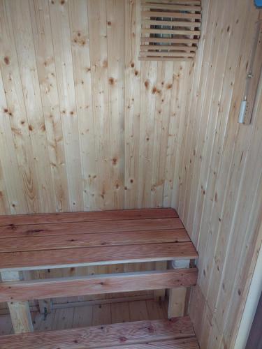 a wooden sauna with a wooden bench in it at "Kod dva kestena"Warm and cozy house with lake view sauna in Međuvršje