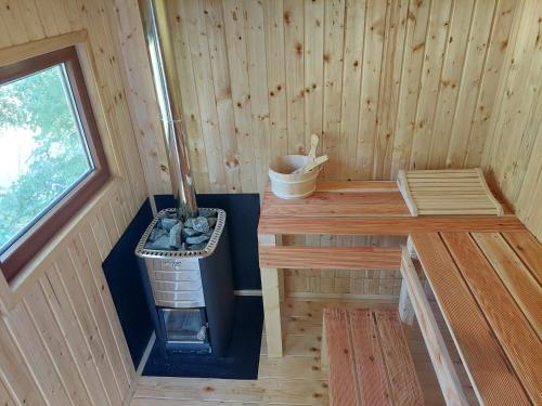 an inside view of a wooden cabin with a stove at "Kod dva kestena"Warm and cozy house with lake view sauna in Međuvršje