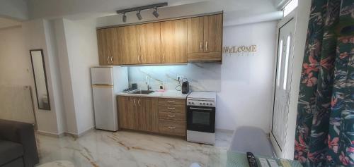 a kitchen with wooden cabinets and a sink and a stove at Balconya in Kavala