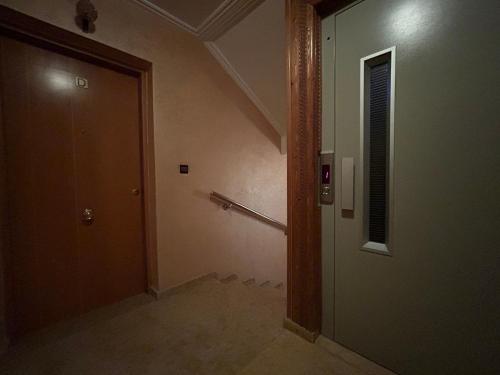 an empty hallway with a door and a window at 800 Miles of Travel in Ouarzazate