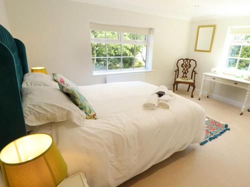 a bedroom with a large white bed with towels on it at Moon Field Lodge in Scunthorpe