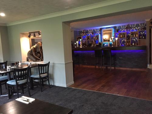 a restaurant with a bar and a large window at South Lawn Hotel in Lymington