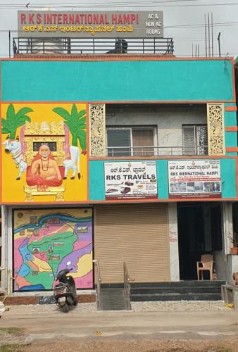 a building with a mural on the side of it at RKS INTERNATIONAL HAMPi in Hampi