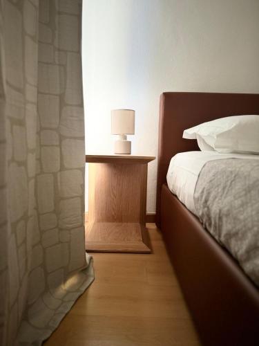 a bedroom with a bed and a table with a lamp at Hotel Locanda Castagnola in Lugano