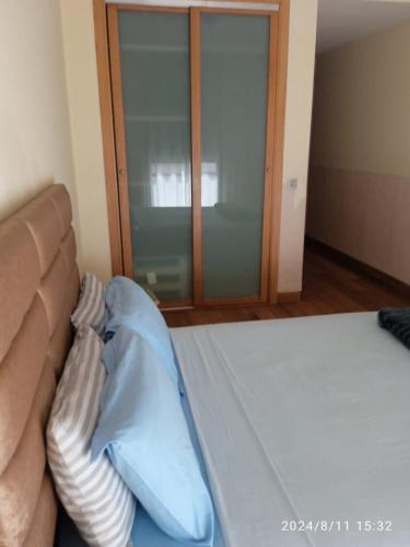 a bedroom with a bed and a glass door at Ocean View Apartment - Anfa Place - in Casablanca