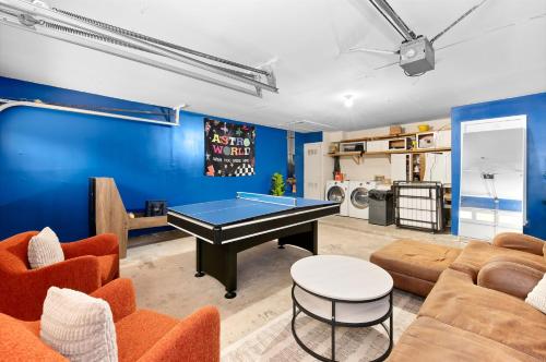 a living room with a ping pong table at Pet Friendly - Q2 & Domain - King Bed - Pool Table in Austin
