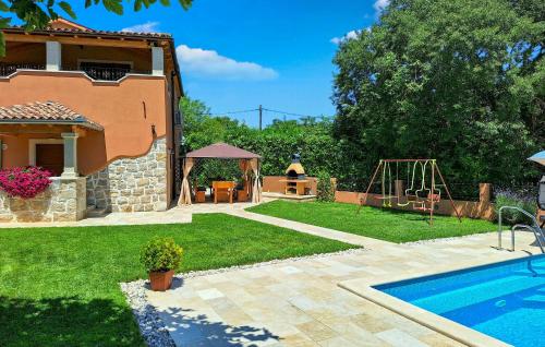 a house with a yard with a pool and a playground at Villa Dajana in Potpićan