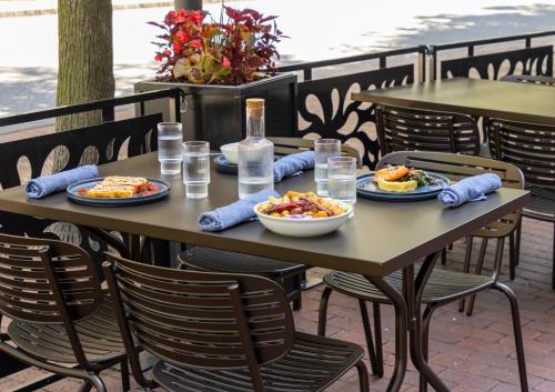 a wooden table with plates of food on it at Crowne Plaza Cleveland at Playhouse Square by IHG in Cleveland