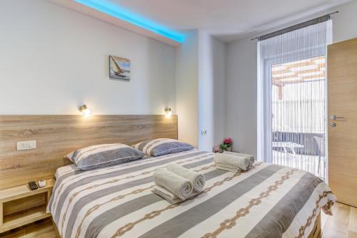 a bedroom with a large bed with a wooden headboard at Villa Milla in Novi Vinodolski