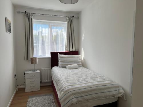 a small bedroom with a bed and a window at Kilnview Guesthouse-Hanley & Staffordshire University in Stoke on Trent