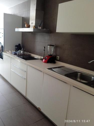 a kitchen with white cabinets and a counter top at Ocean View Apartment - Anfa Place - in Casablanca