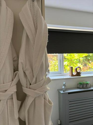 a room with white towels hanging on a window at Secret Gem 1 Bed Garden Flat Private Luxury Hot Tub in Bournemouth