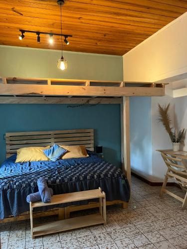 a bedroom with a bed with a wooden ceiling at Hostal Casa Gaia in San Cristóbal de Las Casas