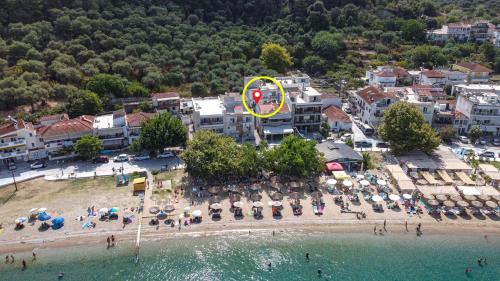an aerial view of a beach with umbrellas and chairs at MarGio Bay in Limenas