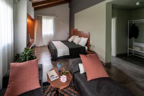 a hotel room with a bed and a couch at Villa Agavì in Marano sul Panaro