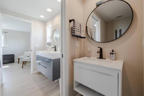 a bathroom with two sinks and a mirror at Welcome To Sanctuary & Flair - Casa de Photograph in North Fort Myers