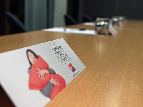 a card on a table with a picture of a woman at ibis Montpellier Centre Polygone in Montpellier