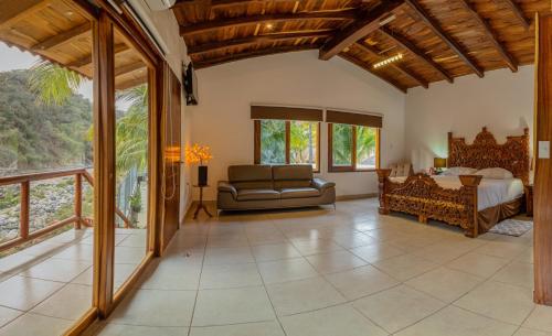a living room with a bed and a couch at La Dulce Vista Hotel & Villas - Sierra Madre Puerto Vallarta in Puerto Vallarta