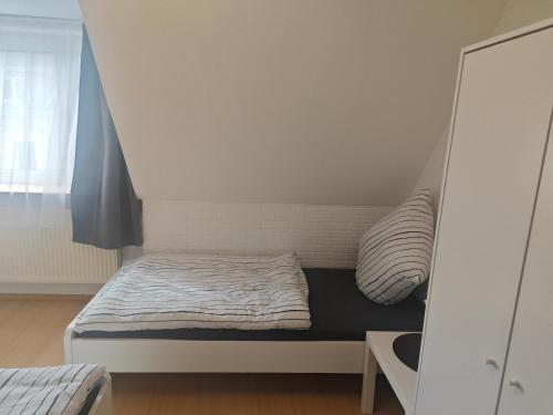 a small bed in a room with a bed frame at Work and Stay Eschweiler 80 Qm 5 Betten 2 Schlafzimmer,Neu in Eschweiler