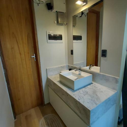 a bathroom with a sink and a mirror at Tokai Surubi'i in Colonia Mariano Roque Alonso