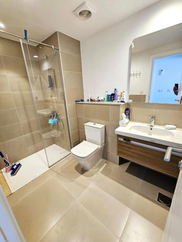 a bathroom with a shower and a toilet and a sink at Townhouse Villa Marassi North Coast in El Alamein
