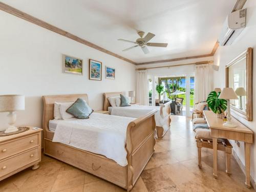 a bedroom with two beds and a table at Tamarind Villa - Sugar Hill in Saint James