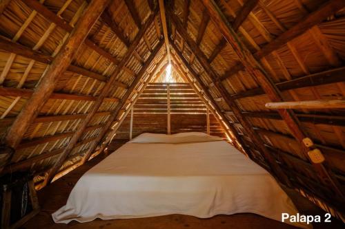 Ένα ή περισσότερα κρεβάτια σε δωμάτιο στο Ecolodge Tubagua Puerto Plata