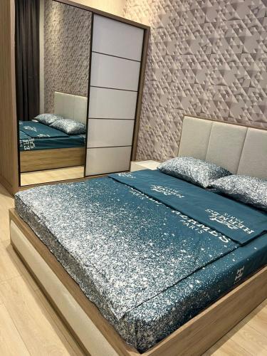 a bedroom with two beds and a mirror at Apartment in the city center on Bagramyan avenue 23 in Yerevan