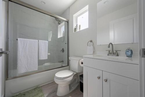 a white bathroom with a toilet and a sink at Prime new beautiful studio in burbank in Burbank