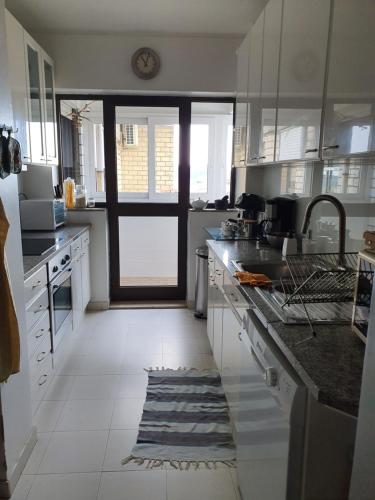a kitchen with a sink and a door to a kitchen at BEST OF NATURE 1, Matosinhos beach, Porto city parc, METRO in Matosinhos