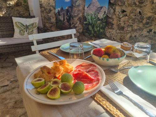 a table with a plate of fruit on a table at Trulli Di Spinaruta in Grottaglie