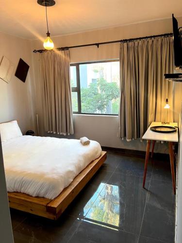 a bedroom with a large bed and a window at The Concept in Centurion