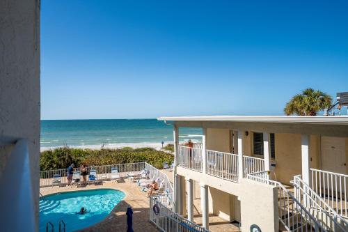 a view of the beach from the balcony of a beach house at Emerald on the Water - Formerly Belleair Beach Club in Clearwater Beach