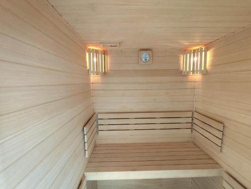 a sauna with two lights and a clock in it at Solar Do Conde Garden Hotel in Capelas