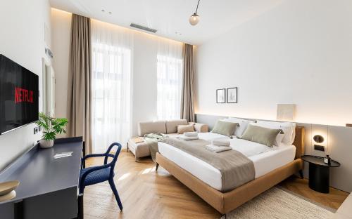 een slaapkamer met een groot bed en een bank bij Catalog Boutique Rooms Cluj-Napoca in Cluj-Napoca