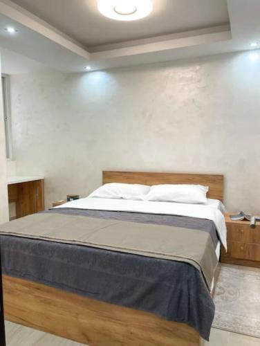 a bedroom with a large bed in a room at Tihanas apartment in Kotor