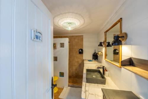 a bathroom with a sink and a mirror at Loft en Tarifa con vistas a África in Tarifa
