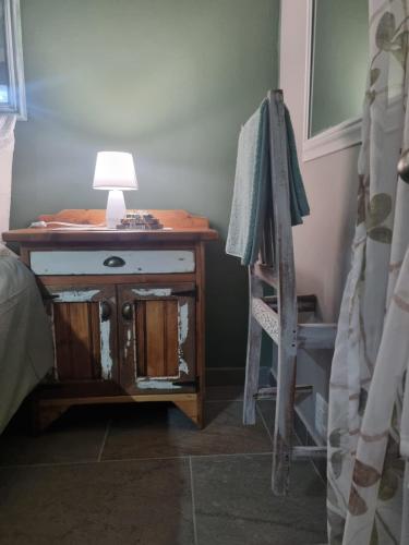 a room with a desk with a lamp and a ladder at Grace B&B in Potchefstroom