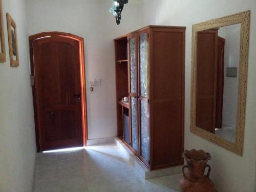 a room with a door and a mirror on the wall at Hotel Portal del Santo in Cafayate