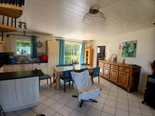 une cuisine avec une table et des chaises dans une pièce dans l'établissement Villa Le grand bleu 7 personnes Vue lac, à Saint-Jorioz