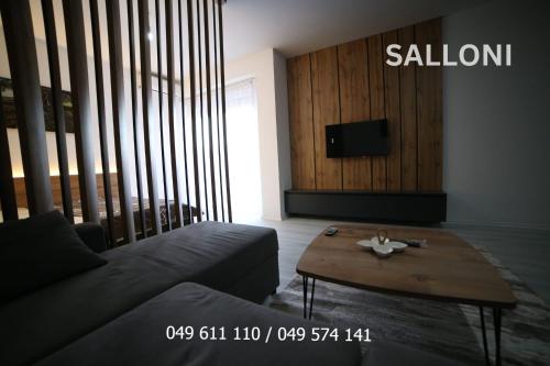 a living room with a couch and a coffee table at Medi Premium in Mitrovicë