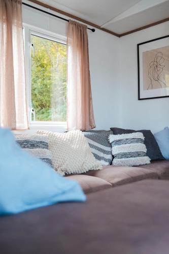 a couch in a living room with a window at Foxglove Lodge in New Quay