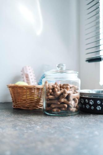 a glass jar filled with nuts sitting next to a basket at Foxglove Lodge in New Quay