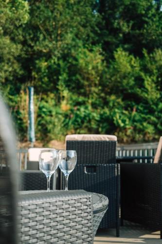 two wine glasses sitting on top of a table at Foxglove Lodge in New Quay