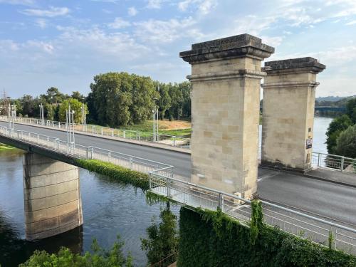 a bridge over a river next to a road at Maison de ville in Port-Sainte-Foy-et-Ponchapt